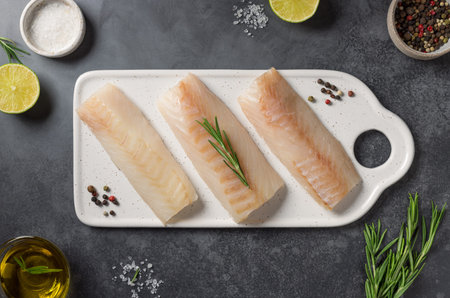 Fresh raw cod fish with ingredients for cooking