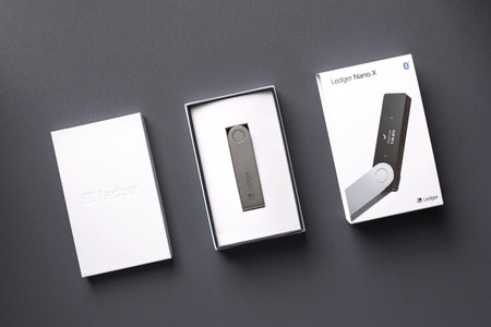 Russia, Krasnodar - April 15, 2022: Cryptocurrency hardware wallet Ledger Nano X in packaging on...