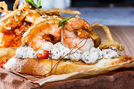 Bruschetta with shrimp, onion fries and salad. Macroの写真素材