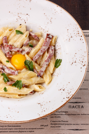 Pasta Carbonara with chicken egg yolk and parsley.の写真素材