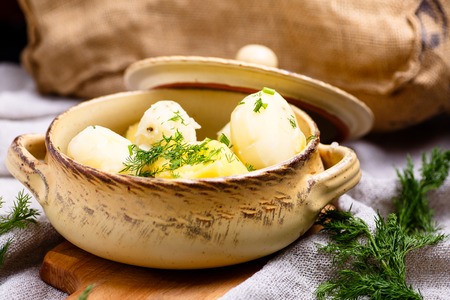 Boiled potatoes sprinkled with dill is in the pot.の写真素材