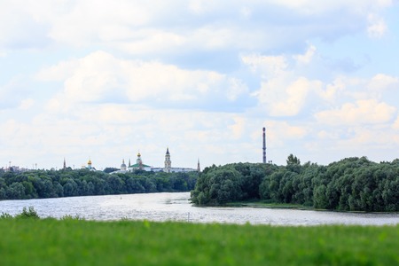 The Orthodox Church stands on the banks of the river, summer, trees, grass.の写真素材