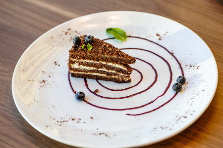 Coffee layer cake with blueberries and mint.の写真素材