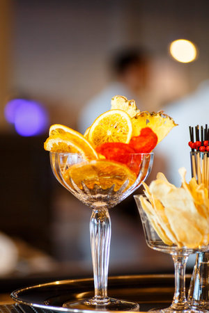 Chips from fruit and other supplies for making a cocktail at the bar.