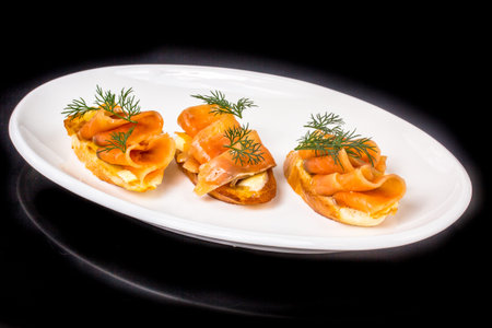 Sandwiches with salted salmon lie on the plate.