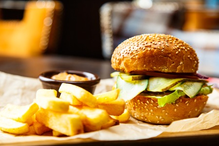 Burger, where a lot of cucumbers with French fries is on the Board.の写真素材