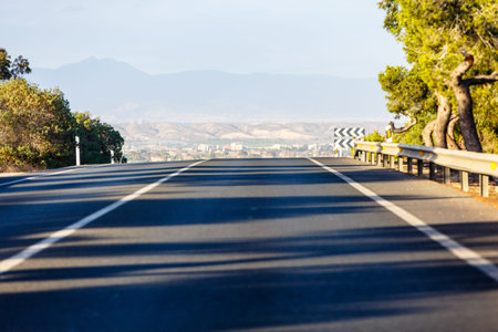 Receding into the distance, empty road in the mountains, summer.