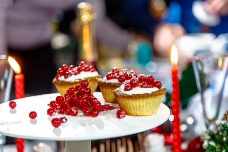 Christmas dessert - cream puffs and red currants on a backgroundの写真素材