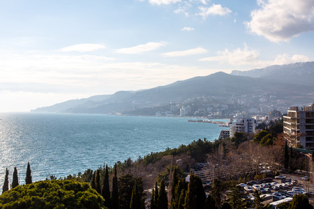 Crimea, Yalta. January 2017. City view of Yalta from the top, overlooks a Bay of the Black sea, mountains, house under construction, and car Parking.のeditorial素材