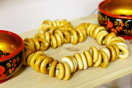 Russian dessert Sushka (drying) are on the shelf next to the bowls painted with Khokhloma ornament.の写真素材