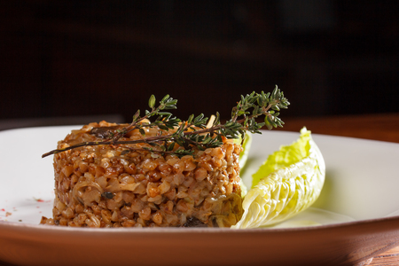 Buckwheat porridge with fried onions and a sprig of thyme. A classic dish of Russian cuisine.の写真素材