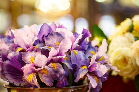 Purple irises are in a large vase. It is possible that this flower shop.