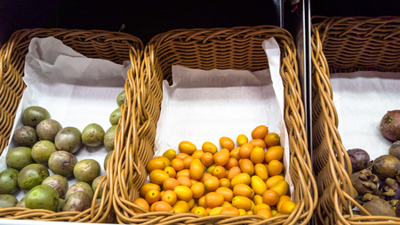 Different vegetables and fruits in baskets on the counter of the supermarket.の写真素材