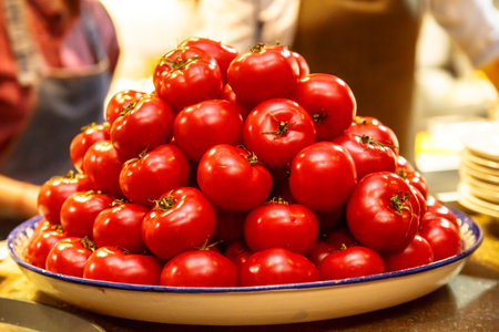 The pile of tomatoes is on the counter in the store.の写真素材