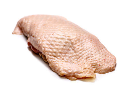 Raw duck breast lying on a white background, not isolated, with a shadow.の写真素材
