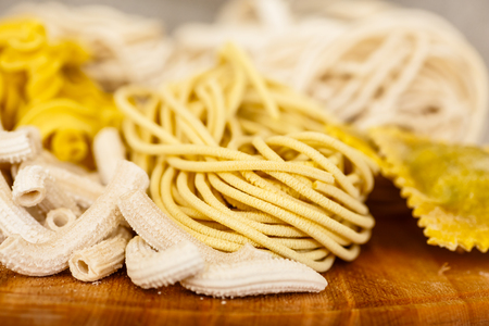 Different types of pasta and ravioli to lie on the Board.の写真素材