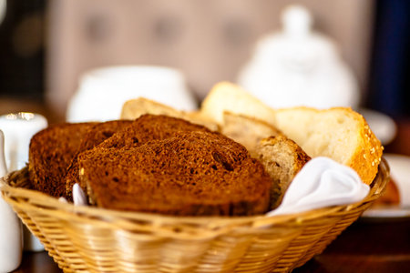 Basket with different types of bread sliced in the restaurant.