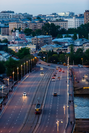 Evening Moscow panorama. Road bridge over the river little machines.の写真素材
