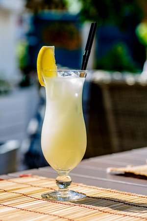 Yellow lemonade from the lemon in the glass on the table. The summer heat.の写真素材