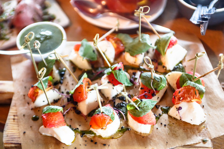 Appetizer mozzarella and roasted tomatoes are on the Board.の写真素材