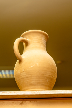 A pottery. Pots and jars without a pattern are on the shelves.の写真素材