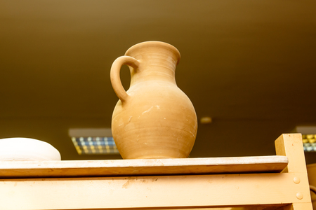 A pottery. Pots and jars without a pattern are on the shelves.の写真素材