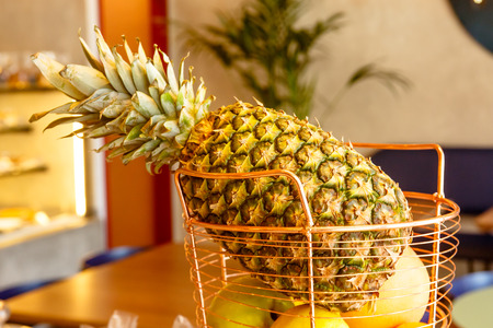 Pineapple and other fruits are in the shop windowの写真素材