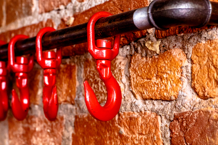 Red hooks on the brick , as decorative elements brutal bar or restaurant.の写真素材