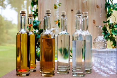 Transparent bottles of different alcoholic beverages - cordials and liqueurs.の写真素材