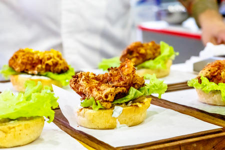 The chef prepares a Burger with beef, salad and vegetables.の写真素材