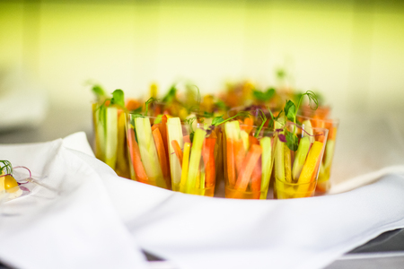 Slices of carrots, celery, cucumber sauce with a Cupの写真素材