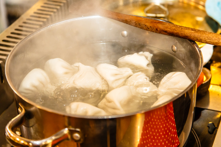 Traditional Georgian khinkali are cooked in a large saucepan.の写真素材