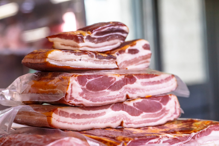 Bacon and sausages in butcher's shopの写真素材