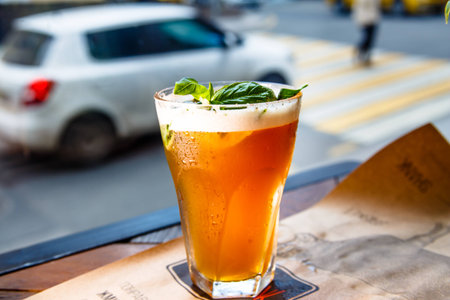 Iced tea in a misted glass is on the table.