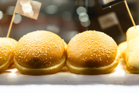 Buns with sesame for burgers are on the counter of the store.