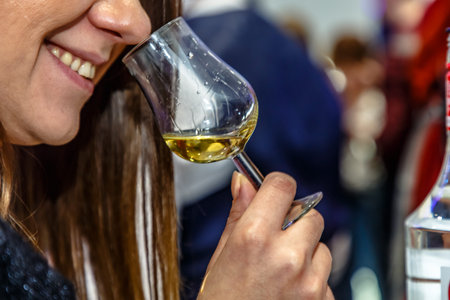 Glass of wine in the hands of the girl at the party