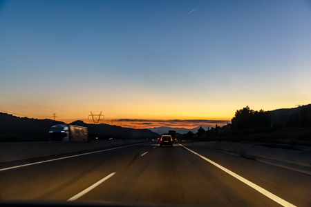 Highway between mountains in the eveningの写真素材