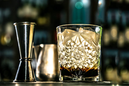 White Russian cocktail. The bartender prepares it in a glass of ice