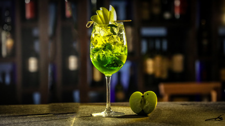 Green cocktail with Apple liqueur revolves on a black background.の写真素材