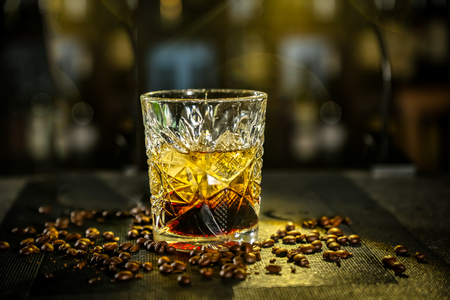 black Russian cocktail. The bartender prepares it in a glass of iceの写真素材