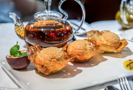 Chinese cuisine. Desserts with passion fruit and a pot of tea