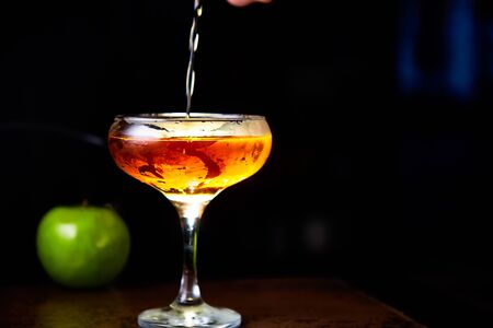 Red cocktail with lemon slice and Appleの写真素材