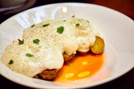 Baked potatoes with Parmesan sauceの写真素材