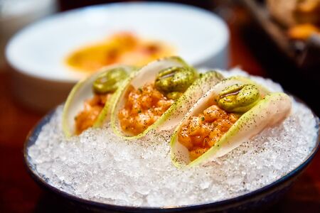 Ceviche or salmon tartare in daikon slices.の写真素材