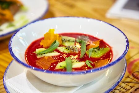Fruit soup with strawberries, orange, kiwi and tarragon.の写真素材