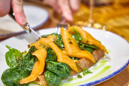 Bruschetta with salmon, spinach and poached eggの写真素材