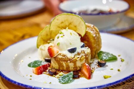 Pancake with ice cream and fresh berries are on the plateの写真素材