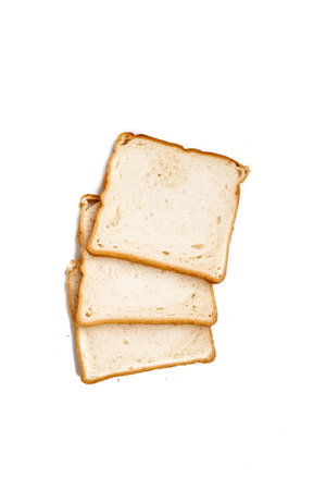 Slices of wheat bread for toast on white isolated backgroundの写真素材