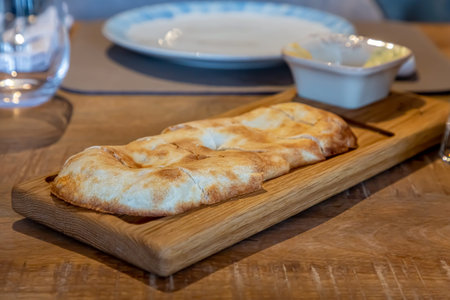 Homemade wheat bread lies on a wooden board