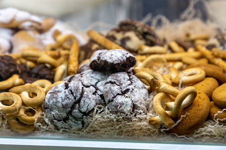 Various cookies and pastries are in the window of the confectionery shopの写真素材